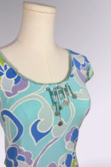Mannequin wearing a blue and purple patterned top with decorative elements on a white background