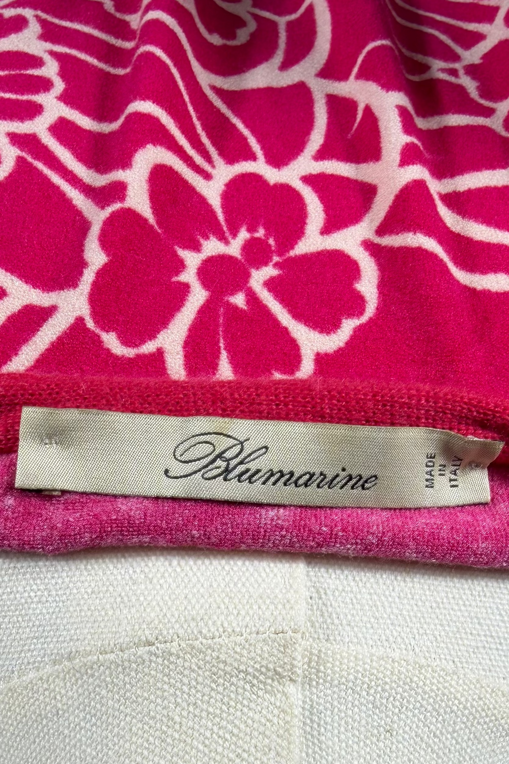 Pink floral patterned fabric with a Blumarine label on a mannequin.