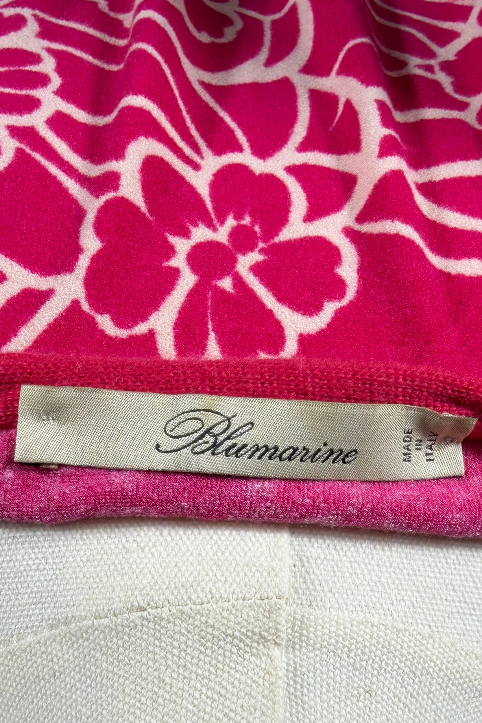 Pink floral patterned fabric with a Blumarine label on a mannequin.