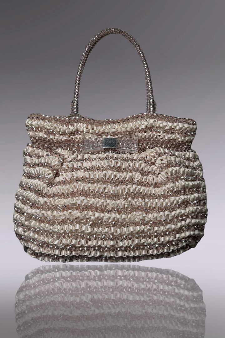 Handbag with a textured pattern on a reflective surface