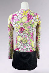 Colorful floral and lemon patterned top on a mannequin with a black skirt.