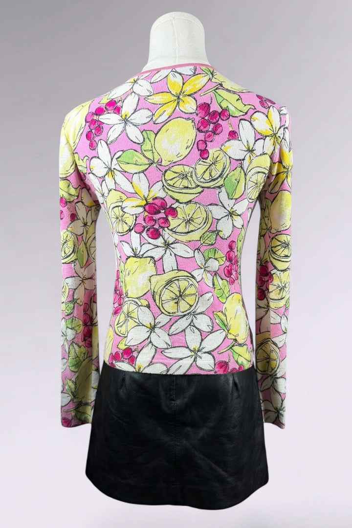 Colorful floral and lemon patterned top on a mannequin with a black skirt.