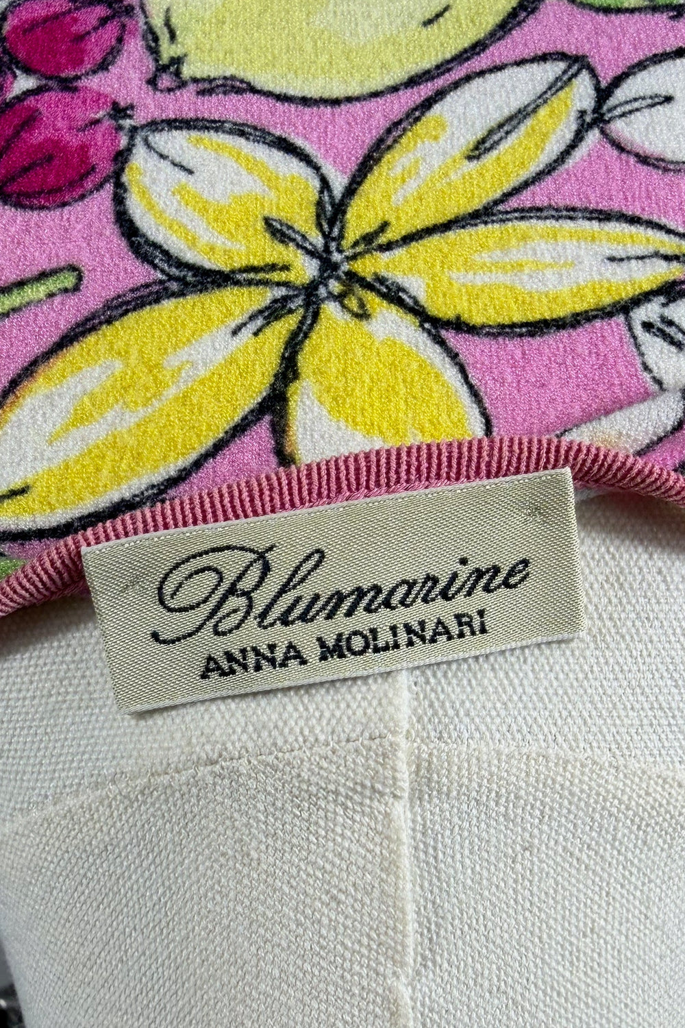 Product with Blumarine label on a pink background featuring lemons and flowers.